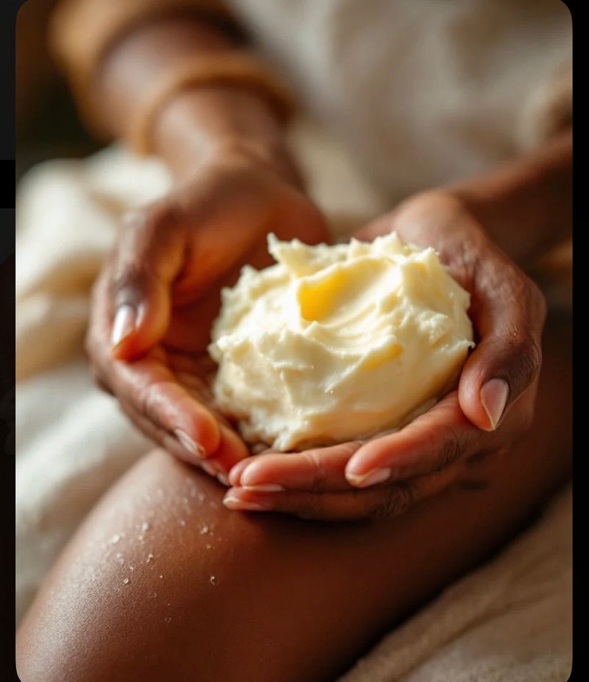 Hands cupping a scoop of whipped Juju Butter , the rich, fluffy texture