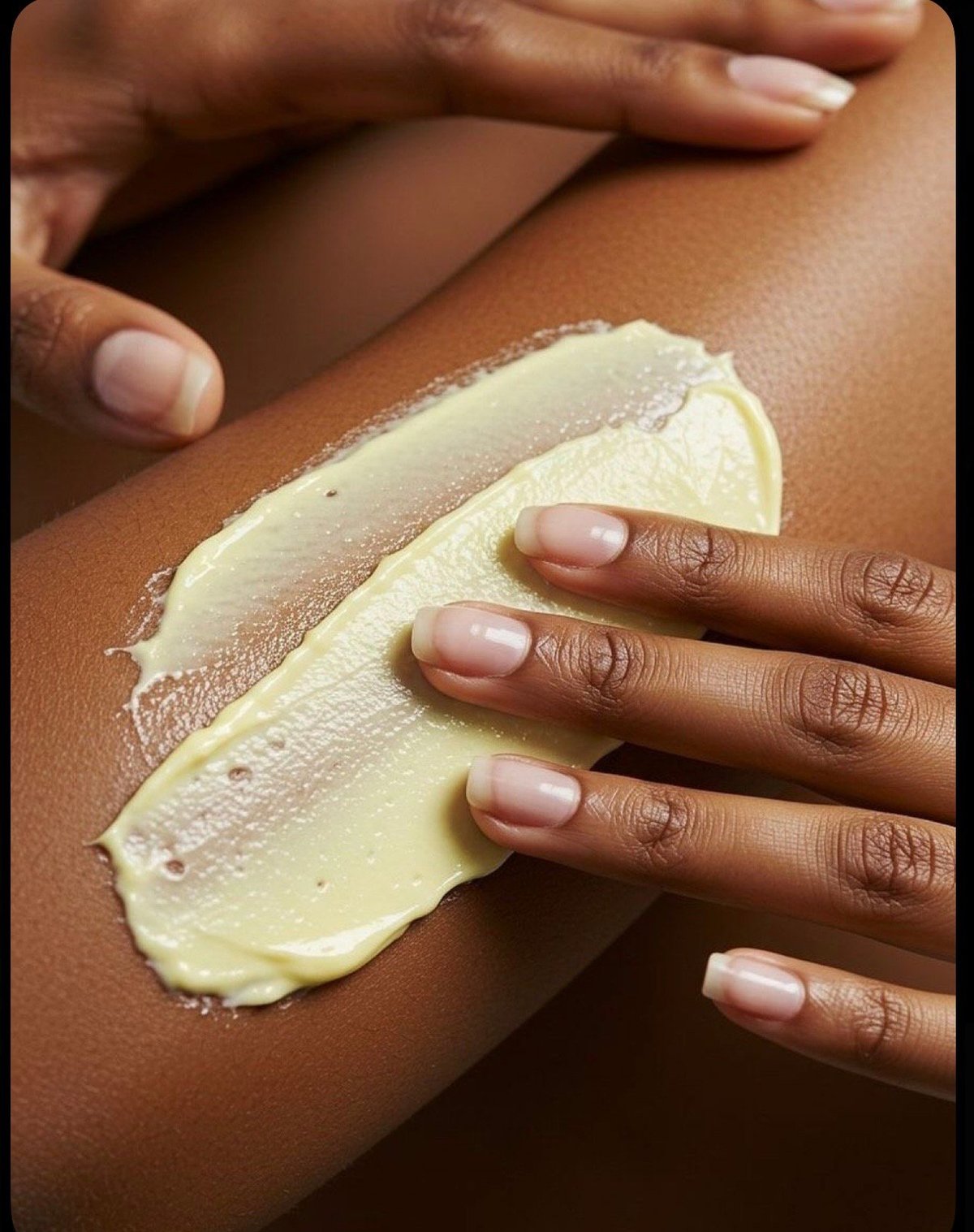 Hand swatch of Juju Butter on brown skin showing the rich, natural finish
